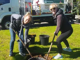 Amy Edwards and her sister digging a hole