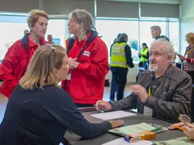 Staff speak to residents at a mock evacuation centre