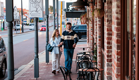 A couple walking along Beaufort Street
