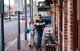 A couple walking along Beaufort Street