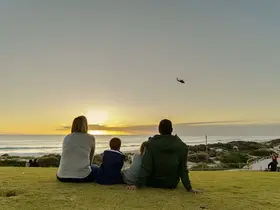 A family watching the sun set