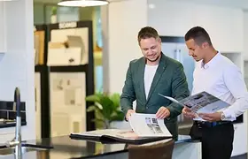 Two men looking at their business marketing materials