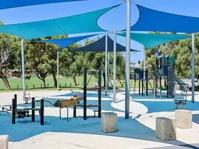 a playground with blue and green shade