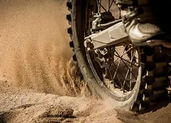 A motorbike skidding in dirt