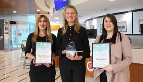 The Customer Experience team holding their awards