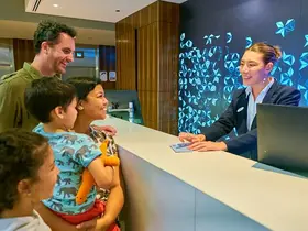 A family checking in at Rendezvous Hotel Scarborough