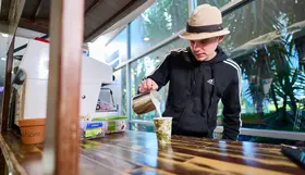 a man pouring milk into a cup