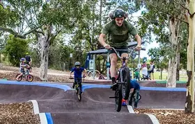 a man on a bike jumping over a ramp