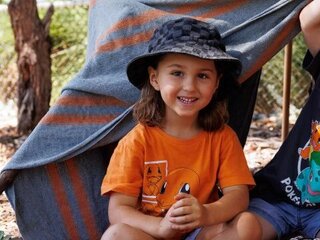 two children sitting in a tent