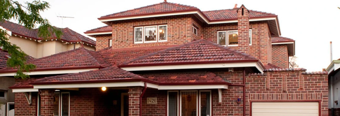 a brick house with a red roof