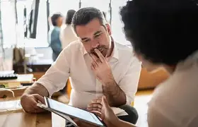 Two people looking at an iPad