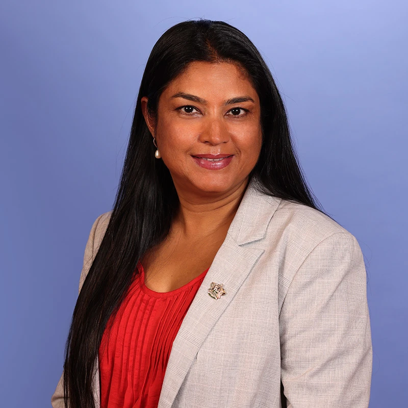 a woman with long black hair wearing a suit jacket and red shirt