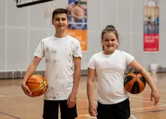 Children holding basketballs