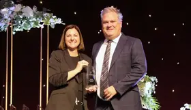a man and woman holding a trophy