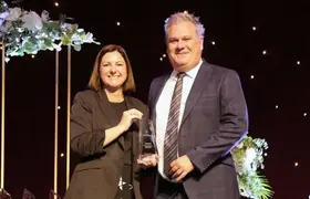 a man and woman holding a trophy