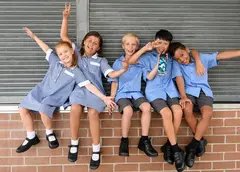 Schoolchildren sitting on a wall