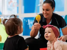 A crèche staff member and children
