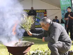 Elder Len Yarran conducting a smoking ceremony