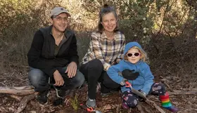 a group of people sitting in the woods