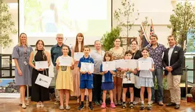 a group of people holding certificates