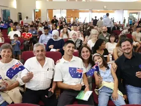 A family holding Australian flags