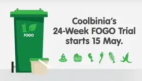 a green trash can with a lid