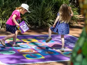 Children playing on a monster motif