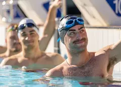 Swimmers lined up in a pool