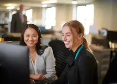 Staff members looking at a screen