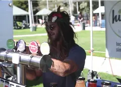 A person pouring drinks at an event