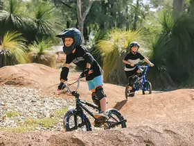 Children riding bikes at Bina Parkland