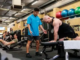 A staff member helping a member with their form