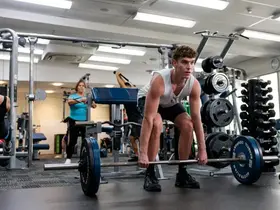 A man lifting weights in a gym