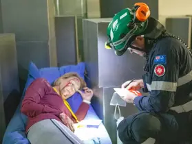A paramedic speaks with a 'casualty'