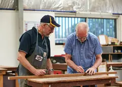 Two older men woodworking