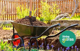 A wheelbarrow filled with mulch