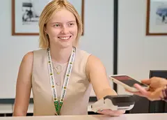 A staff member wearing a Sunflower Hidden Disabilities lanyard