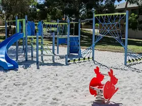 a playground with a swing and a playground equipment