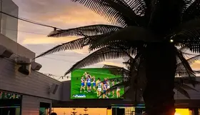 A football game on a TV at a bar