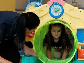A crèche staff member and children