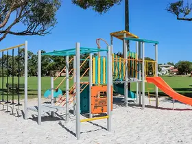 a playground with a slide and grass