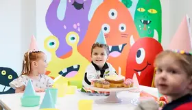 A children's party with the monster mural in the background