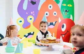 A children's party with the monster mural in the background