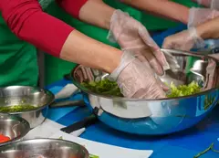 a person in gloves preparing food