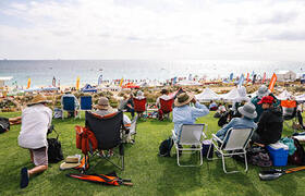 Event attendees sitting on grass