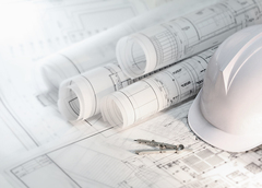 Building plans and a hard hat