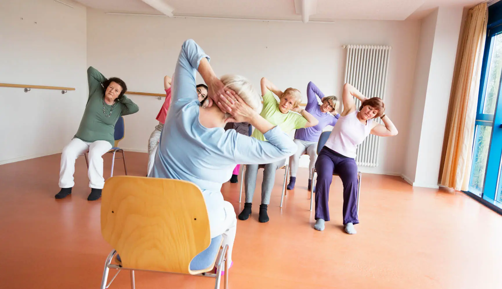 Group of women doing chair yoga