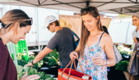 A resident purchasing vegetables at the Stirling Farmers Markets