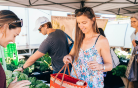 A resident purchasing vegetables at the Stirling Farmers Markets