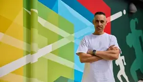 Artist Vik with his mural